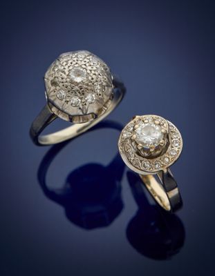 two gold rings with diamonds on a blue background
