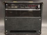 a close up of a black amplifier with a red light on top