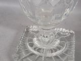a glass vase with a candle inside of it