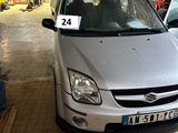 une voiture argentée garée dans un garage, avec une plaque d'immatriculation à l'avant
