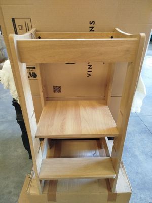 a wooden chair that has a shelf on top of it