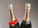 two bottles of champagne sitting next to each other on a table