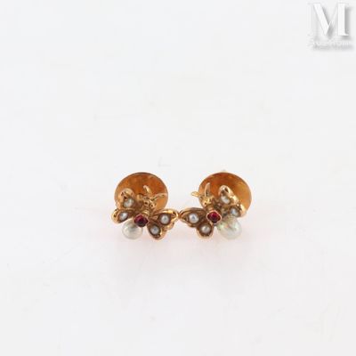 a pair of gold earrings with pearls and garnets