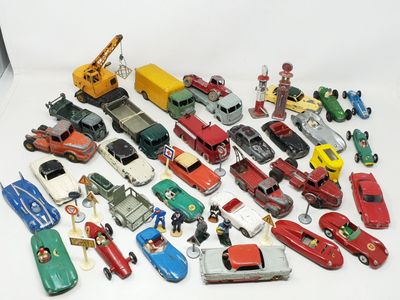 a lot of toy cars and trucks on a white surface