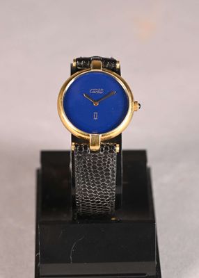 an image of a blue watch on a black stand