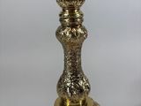 a close up of a silver plate on a stand with a candle