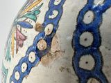 a close up of a vase with a design on it