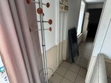 a room with a white tiled floor and a pink curtain