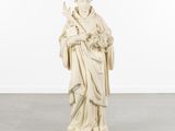 a white statue of a woman holding a bouquet of flowers