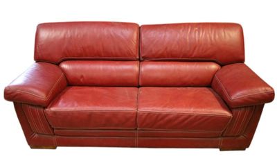red leather loveseat on a white background