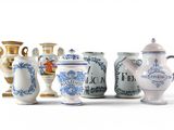 many vases that are lined up on a white surface