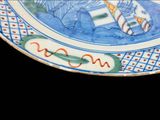 a blue and white plate with a picture of a fish on it