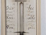 an old fashioned thermometer hanging on a wall