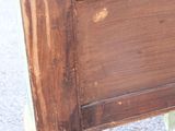 a wooden bench that has been painted brown and white