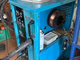 a blue machine that is sitting in a garage