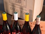several bottles of wine sitting on a table next to a box of wine