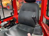 a black seat on the back of a red truck