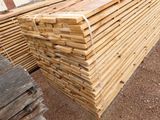 a pile of lumber sitting on the ground in the yard