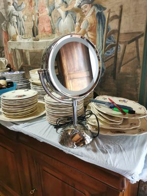 many plates on a table with a mirror on it