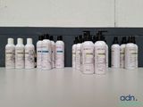 many bottles of different types of hair products on a table