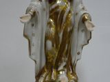 a statue of a woman that is sitting on top of a table