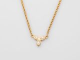 a gold necklace with a butterfly pendant on a chain