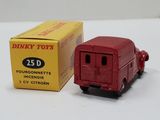 a red toy truck sitting next to a box of dinky toys
