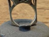 a ring that is sitting on top of a wooden stand