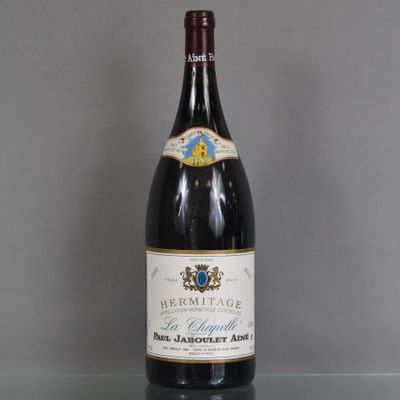 a bottle of wine sitting on top of a table next to a glass