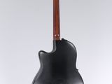 an electric guitar hanging from the back of a black guitar