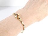 someone is wearing a gold bracelet with blue stones on it