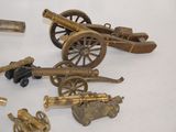 a lot of different types of toy guns on the table