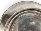 a silver plate on a table with a white background