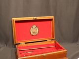a small wooden box with a red cover on it