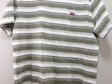 a white and green striped shirt hanging on a hanger
