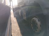 two trucks that are parked next to each other
