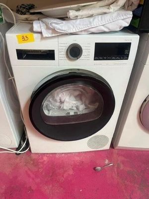 a washing machine and a dryer sitting on a pink floor