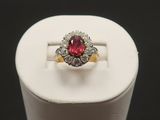 a close up of a pink and white diamond ring on a stand