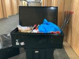 a black trash can with a television in it