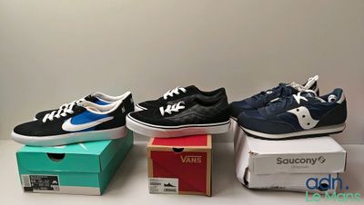 three pairs of shoes are sitting on top of boxes on a table