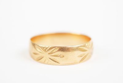 a close up of a gold ring on a white surface