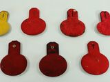 several red and yellow fire hydrants on a white surface