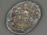 an old silver coin sitting on top of a gray surface