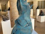 a sculpture of a bird on a pedestal in a museum