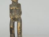 an old wooden statue of a man with a hat on his head