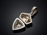 a white gold and diamond pendant on a black background