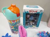 a toy and a cup sitting on a table next to a box