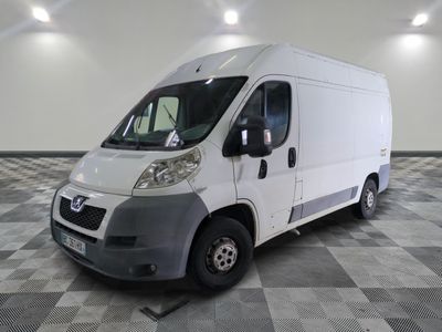 a white van that is parked on a checkered floor