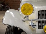 a close up of a white car with a yellow light on it