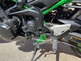 a green and black motorcycle parked on the side of the road